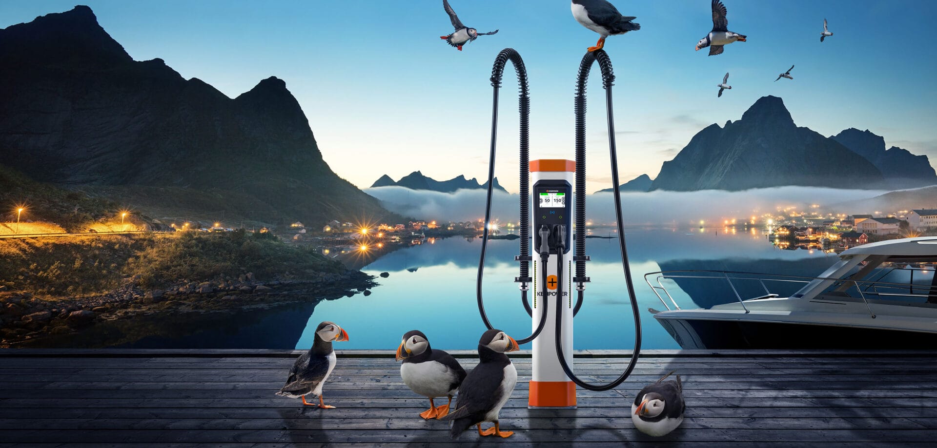A charging station is situated on a wooden dock by a tranquil lake, surrounded by mountainous landscapes at dusk. Several puffins are gathered around the charging station, with a few flying above. Warm lights illuminate a distant lakeside town, providing a serene ambiance.