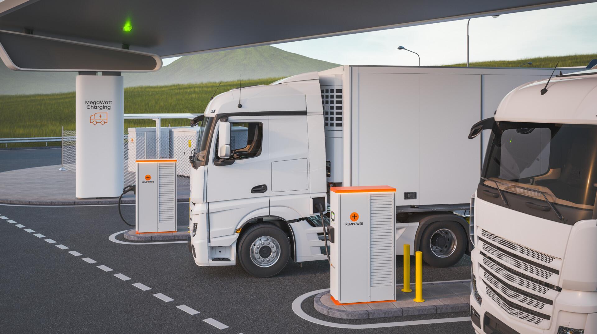 Electric trucks charging at a station with power supply units connected, set against a backdrop of a grassy hill and a clear sky during daytime.